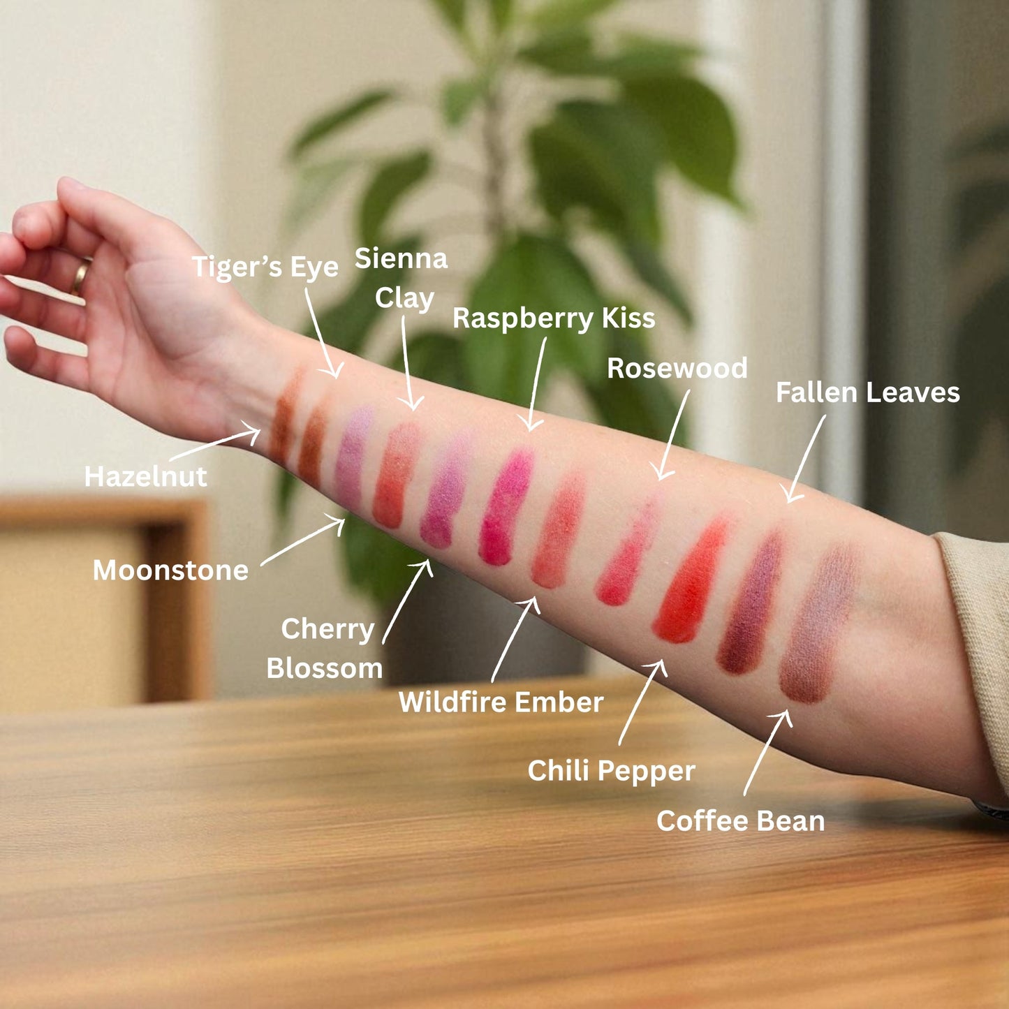 Color swatches on a person's arm with labeled names against a neutral background