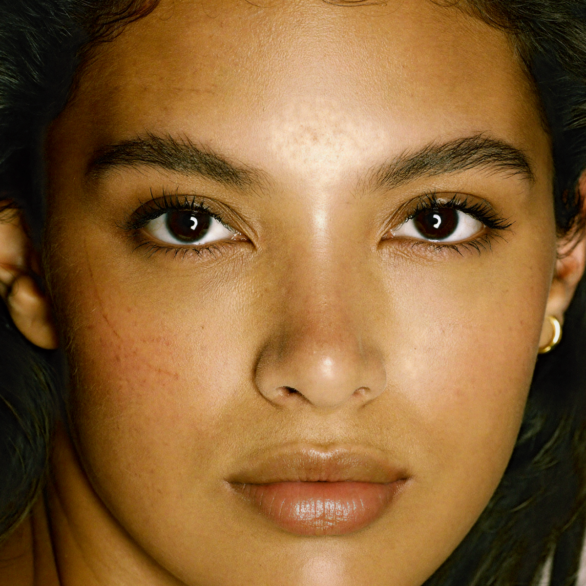 Model wearing MYCO Foundation 634 Light Warm - vegan mushroom-powered foundation for light warm golden skin