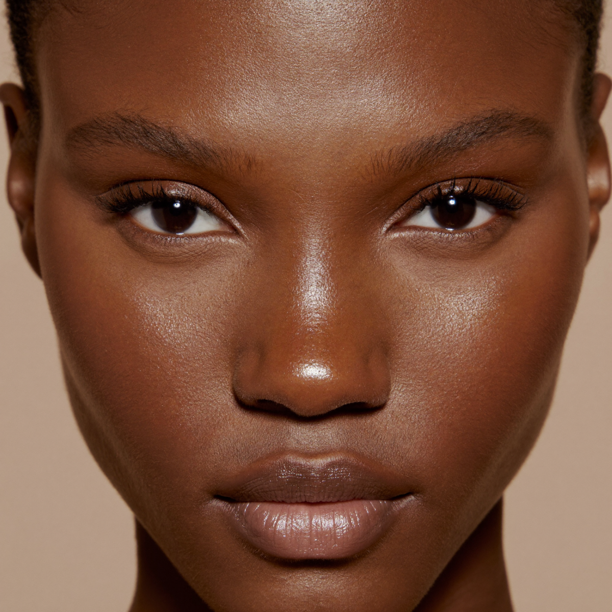 Model wearing MYCO Foundation 649 Dark Warm - vegan mushroom-powered foundation for dark warm skin