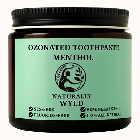 Amber glass jar of Naturally Wyld Ozonated Menthol Toothpaste with bright green label. Highlights include fluoride-free, SLS-free, 100% all-natural, and remineralizing formula. Crisp minty menthol toothpaste designed to freshen breath and support gum health.