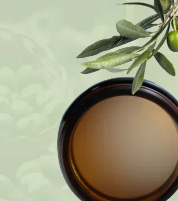 Amber jar of Naturally Wyld Pure Ozonated Olive Oil. Cold-pressed, medical-grade olive oil balm made in Canada. 100% all-natural, showing an open jar with product inside 