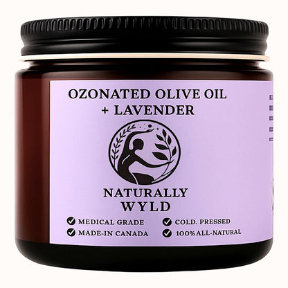Amber jar labeled Naturally Wyld Ozonated Olive Oil + Lavender. Cold-pressed, 100% all-natural calming balm made in Canada. Medical-grade olive oil infused with lavender for skincare and relaxation.