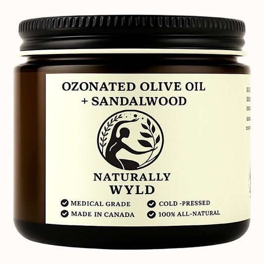 Amber jar labeled Naturally Wyld Ozonated Olive Oil + Sandalwood. Skincare product featuring cold-pressed, medical-grade olive oil with sandalwood essential oil. 100% all-natural, made in Canada, eco-friendly small batch.