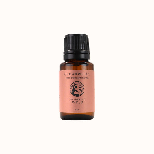 Amber bottle of Naturally Wyld Pure Cedarwood Essential Oil with earthy brown label
