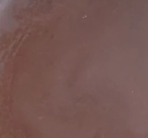 Close-up of a brownish liquid texture  natural makeup