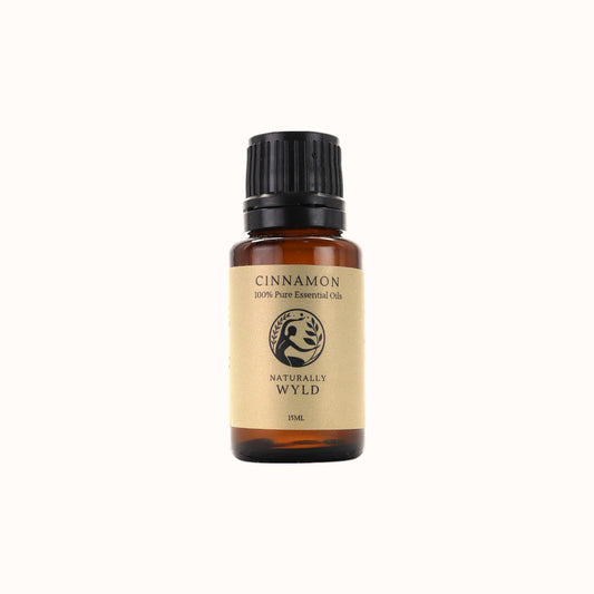Amber bottle of Naturally Wyld Pure Cinnamon Essential Oil with deep red label design