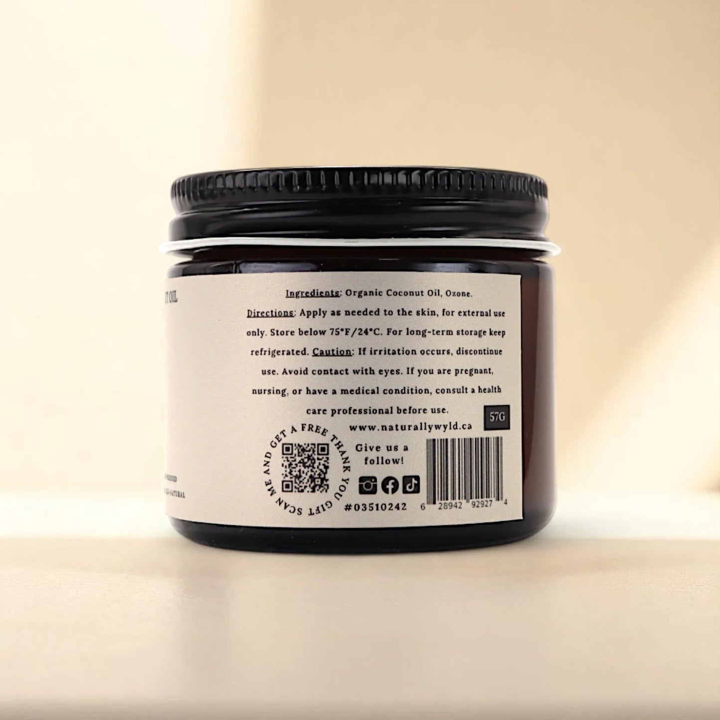 Back label of Naturally Wyld ozonated coconut oil jar showing full ingredient list (organic coconut oil, ozone), external use directions, and clean-label storage tips; commonly chosen for those seeking a plant-based topical oil for skin nourishment and simple skincare routines.