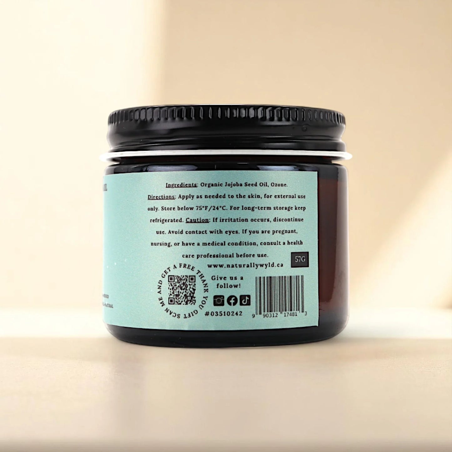 Back label of Naturally Wyld ozonated jojoba oil showing clean ingredient list (organic jojoba seed oil, ozone), suggested external use, and storage guidance; a small-batch product often chosen for daily face care, dry scalp routines, and those seeking ozone-enriched hydration for delicate or combination skin.