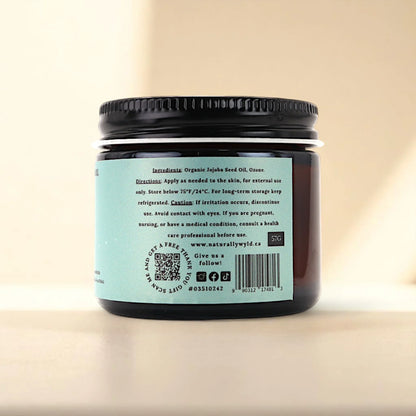 Back label of Naturally Wyld ozonated jojoba oil showing clean ingredient list (organic jojoba seed oil, ozone), suggested external use, and storage guidance; a small-batch product often chosen for daily face care, dry scalp routines, and those seeking ozone-enriched hydration for delicate or combination skin.