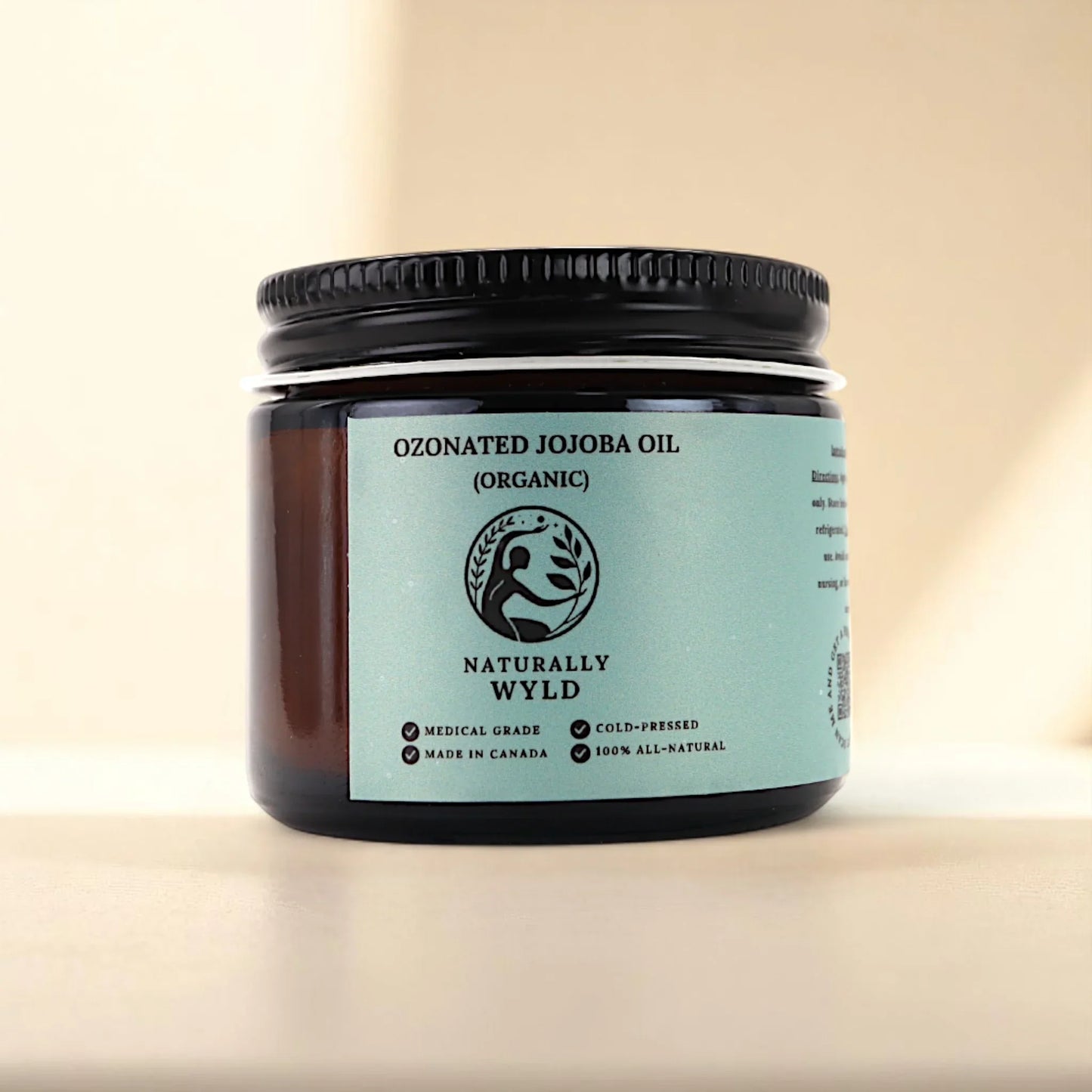 Naturally Wyld ozonated jojoba oil front label – organic, cold-pressed jojoba oil infused with ozone, often used in clean skincare routines for balancing oily skin, supporting sensitive complexions, and moisturizing without clogging pores; made in Canada with 100% natural, non-comedogenic ingredients.