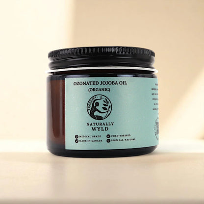 Naturally Wyld ozonated jojoba oil front label – organic, cold-pressed jojoba oil infused with ozone, often used in clean skincare routines for balancing oily skin, supporting sensitive complexions, and moisturizing without clogging pores; made in Canada with 100% natural, non-comedogenic ingredients.