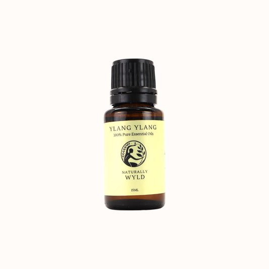 Amber bottle of Naturally Wyld Pure Ylang Ylang Essential Oil with floral label